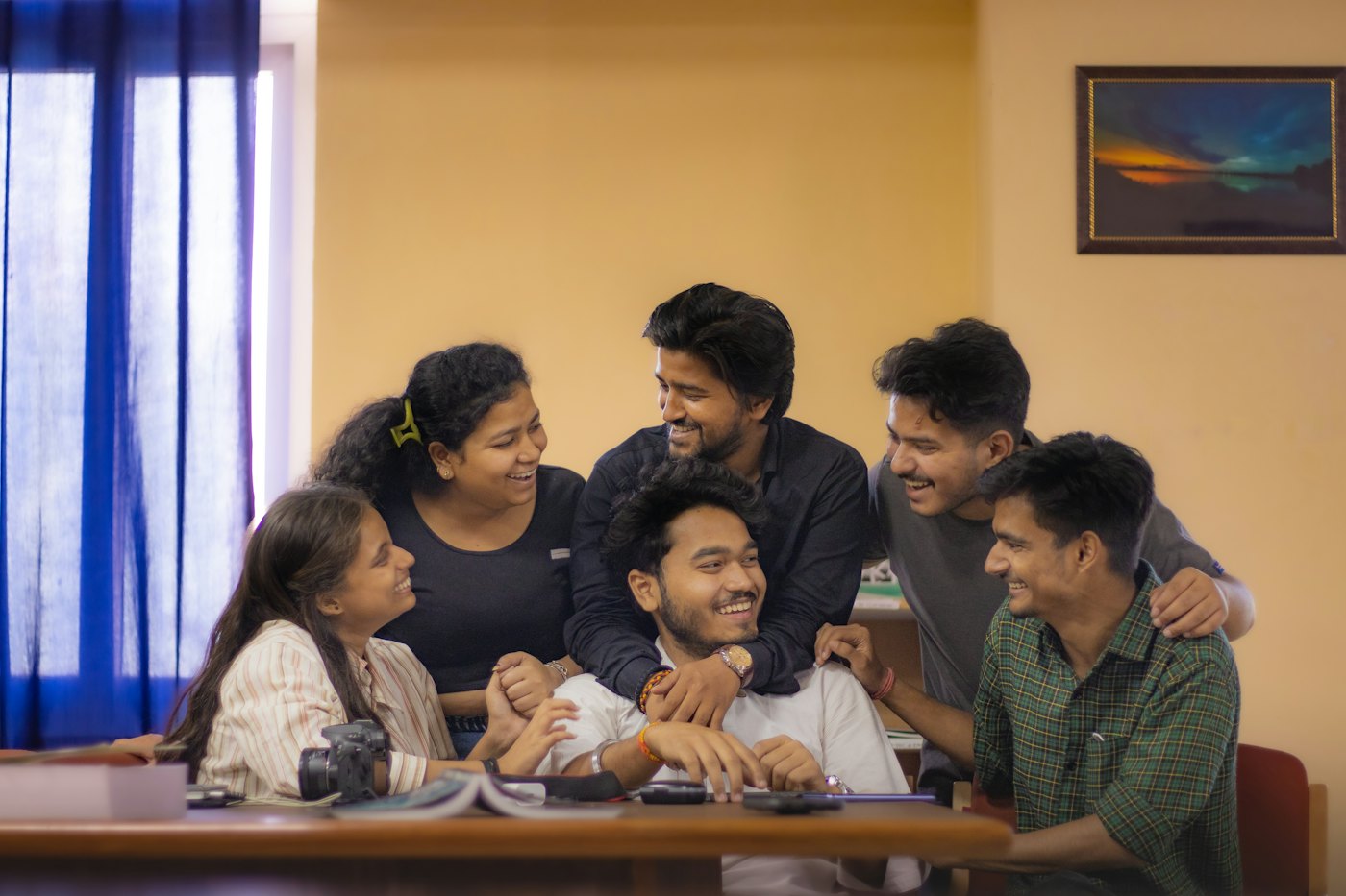 Group of young friends laughing together in a living room