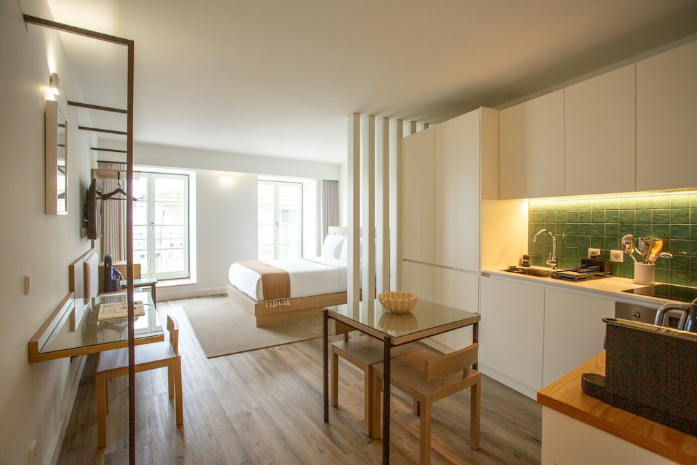 Compact furnished studio apartment with a kitchenette and a bed