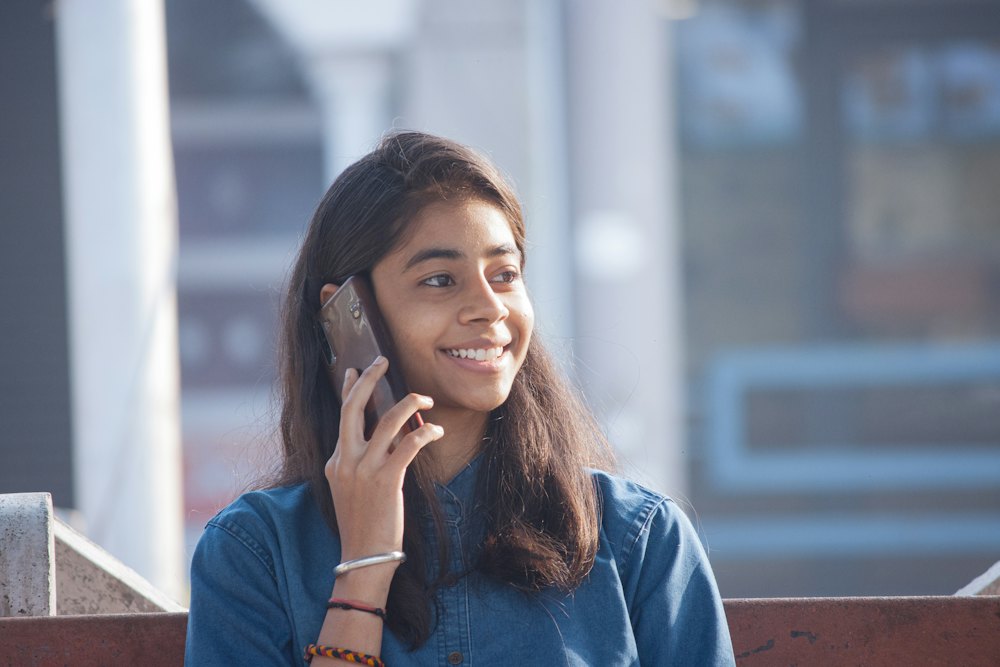 Young woman smiling while talking on her phone